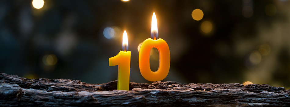 Birthday candles glowing against sparkling background
