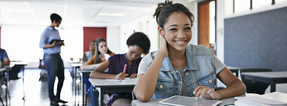 Female student smiling to camera in classroom