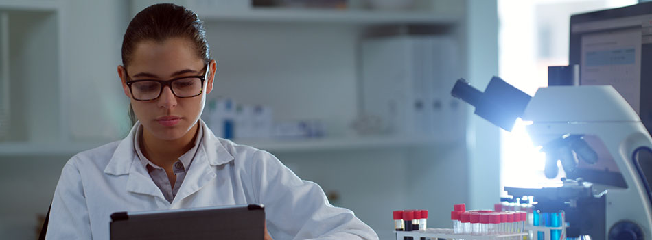 Shot of a young scientist using a digital tablet in a lab