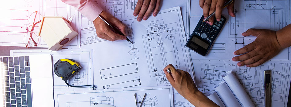 engineers pointing to building on blueprint and using laptop to drawing design building Project in office, construction concept. Engineer concept